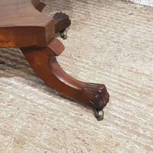 fig 1. A Regency mahogany fold-over table featuring a rounded rectangular hinged top on a central turned pedestal column with four splayed legs and brass castors.