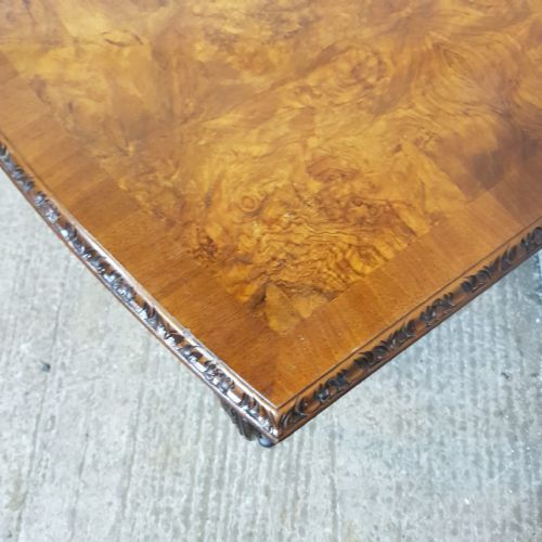 fig 2. A 1920s burr walnut bow-fronted console table featuring carved cabriole legs with shell detail on the knees.