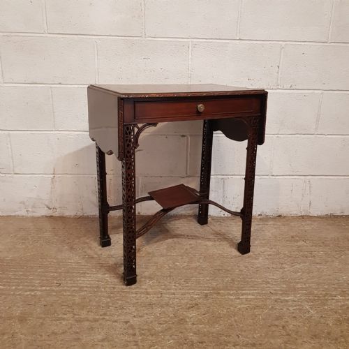 fig 1. A pair of Edwardian mahogany drop-leaf side tables featuring intricate pierced fretwork legs, frieze drawers, and cross-stretchers with central undertiers.