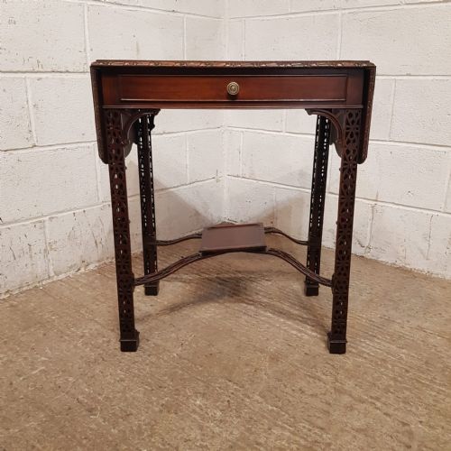 fig 2. A pair of Edwardian mahogany drop-leaf side tables featuring intricate pierced fretwork legs, frieze drawers, and cross-stretchers with central undertiers.