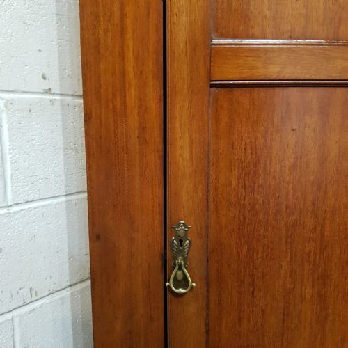fig 1. A tall, narrow mahogany sentry box wardrobe featuring a single three-panel door, brass handle, moulded top cornice, and bracket feet.