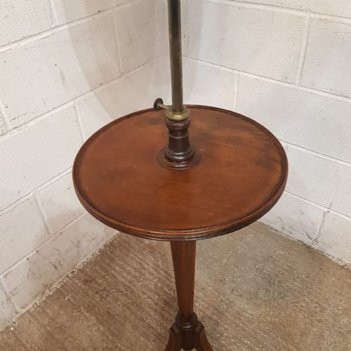 fig 1. A late Victorian mahogany shaving stand featuring a shield-shaped adjustable mirror, a round central shelf, and a turned pedestal on a tripod base.