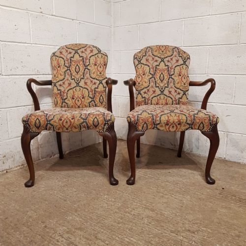A PAIR OF WALNUT FRAMED LIBRARY CHAIRS C1920