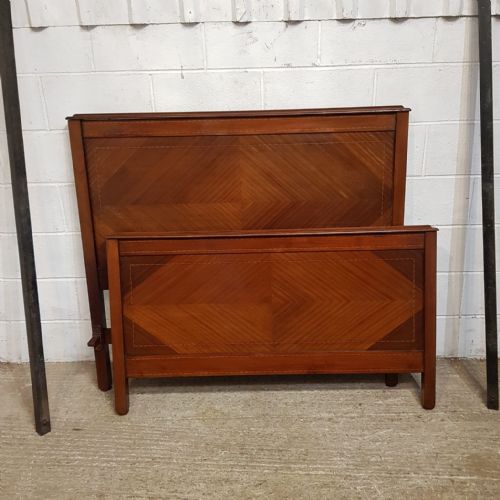 fig 1. An Edwardian mahogany double bedstead featuring geometric diamond parquetry veneered panels on the headboard and footboard.
