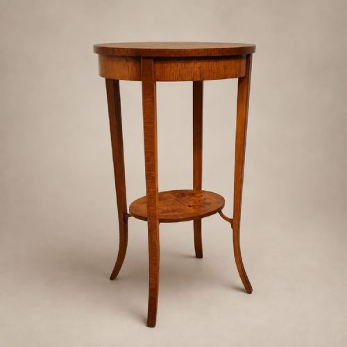 fig 1. A pair of tall 1920s oval walnut side tables featuring slender splayed legs and lower circular undertiers.