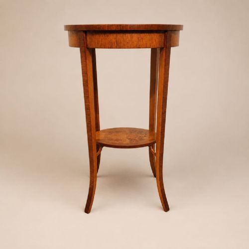 fig 2. A pair of tall 1920s oval walnut side tables featuring slender splayed legs and lower circular undertiers.