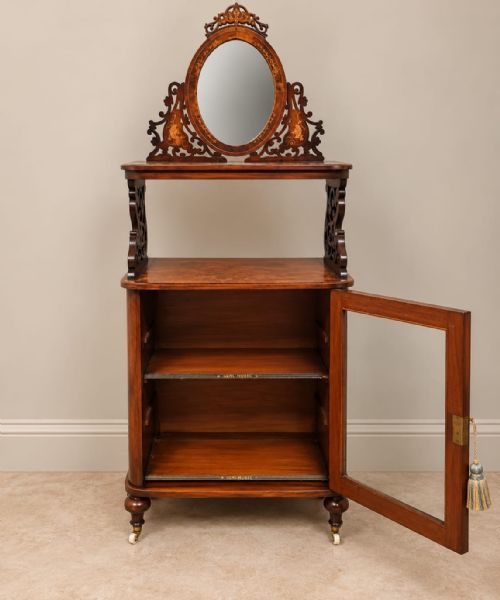 fig 2. A Victorian burr walnut side cabinet with a glazed single door, marquetry inlay details, an upper shelf tier, and an oval mirror crest.