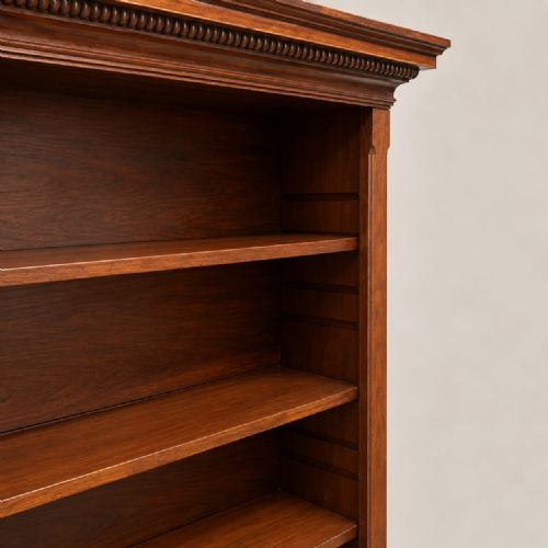 fig 1. A late Victorian mahogany open bookcase featuring four horizontal shelves, lower compartment dividers, and bracket feet.