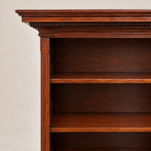 fig 2. A late Victorian mahogany open bookcase featuring four horizontal shelves, lower compartment dividers, and bracket feet.