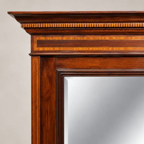 fig 2. An Edwardian mahogany combination wardrobe featuring a full-length mirrored door, an inlaid cupboard, three drawers, and satinwood crossbanding.