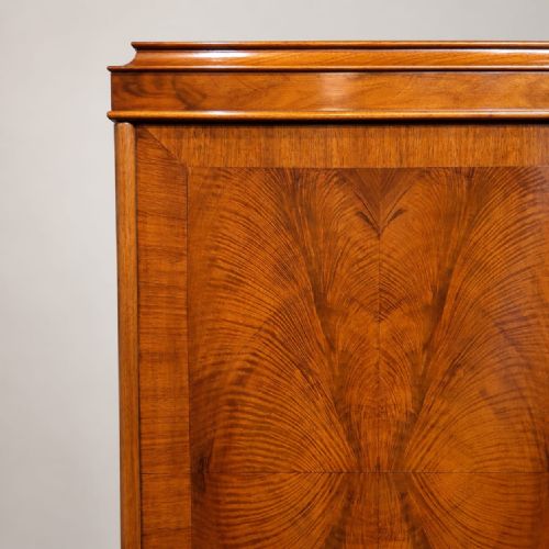 fig 2. A 1920s burr walnut triple wardrobe featuring three doors with book-matched figure patterns and short cabriole feet.
