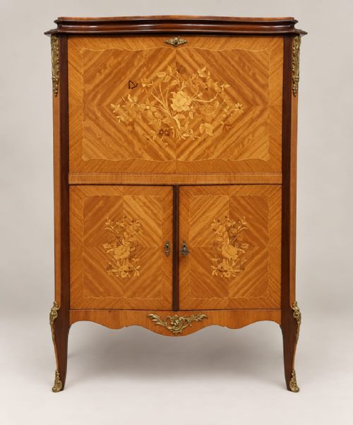 fig 1. A serpentine-fronted walnut and mahogany cocktail cabinet featuring floral marquetry inlay, herringbone veneering, and ornate brass ormolu mounts.