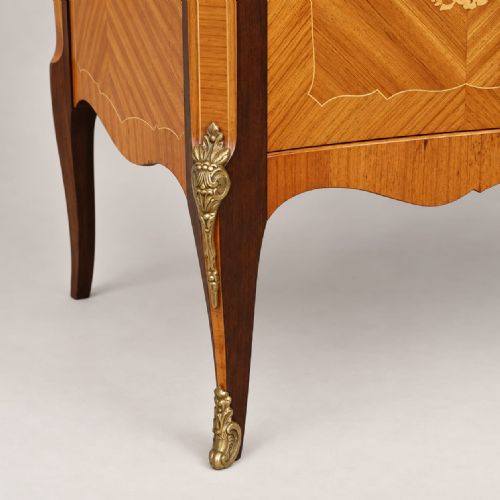 fig 2. A serpentine-fronted walnut and mahogany cocktail cabinet featuring floral marquetry inlay, herringbone veneering, and ornate brass ormolu mounts.