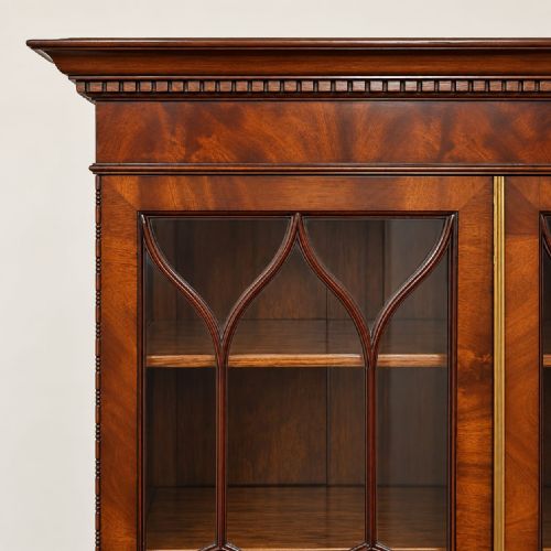 fig 2. An Edwardian Chippendale Revival mahogany bureau bookcase featuring an upper glazed cabinet, slant-front writing desk with flame mahogany oval inlay, lower drawers, and cabriole legs with ball-and-claw feet.