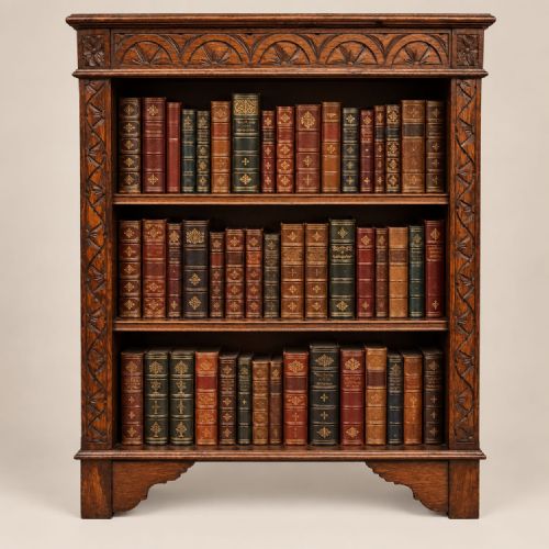 fig 1. A dark oak open bookcase dating to circa 1920 featuring carved lunette moulding along the upper frieze and three internal storage shelves.