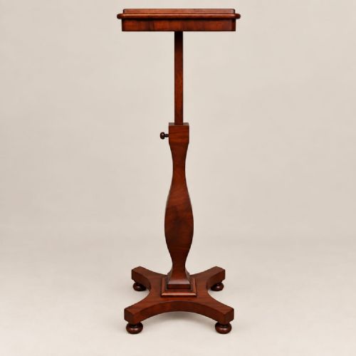 fig 1. A Victorian mahogany music stand featuring an adjustable tilted rest, a turned shaped stem, and a quadform base with turned feet.