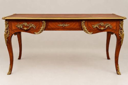 fig 1. An antique French Louis XV style kingwood bureau plat writing desk featuring parquetry veneering, cabriole legs, and gilt-bronze ormolu mounts.