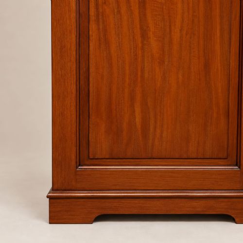 fig 1. An Edwardian double wardrobe constructed from warm brown mahogany featuring two full-length panelled doors and brass handles.