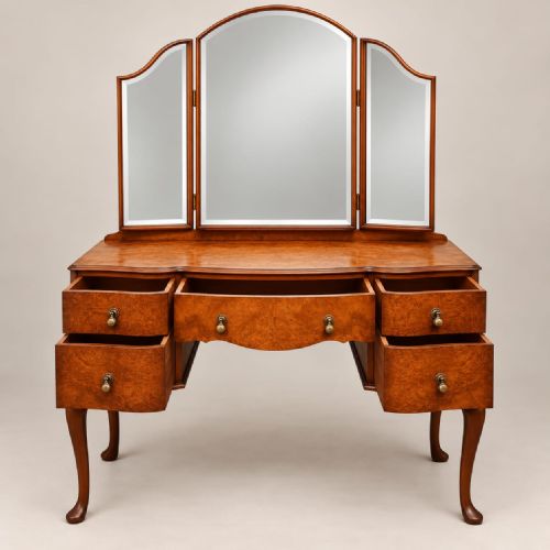 fig 1. A 1920s burr walnut dressing table featuring a serpentine-fronted desk with five drawers, cabriole legs, brass handles, and a three-panel folding mirror.