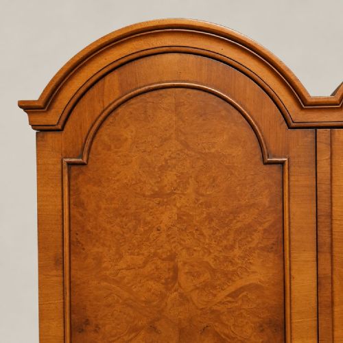 fig 2. A 1920s burr walnut double wardrobe with a double-domed top, twin arched panel doors, and short shaped feet.