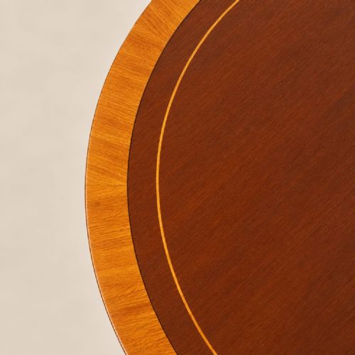 fig 2. A circular mahogany three-tier revolving bookcase featuring vertical slatted sides, central turned columns, and a rotating base mounted on small castors.