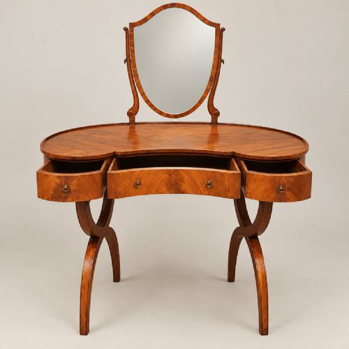 fig 2. A 1920s kidney-shaped timber dressing table featuring three drawers, sweeping curved legs, and an attached shield-shaped swivel mirror.