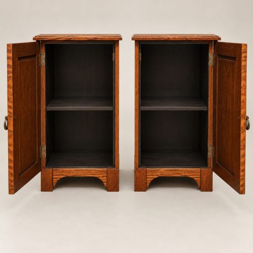 fig 1. A pair of medium oak bedside cabinets featuring single panelled doors, brass teardrop handles, and shaped aprons.