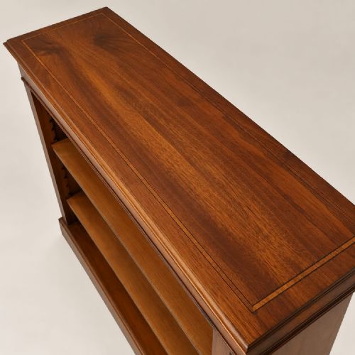 fig 1. A low mahogany open bookcase featuring three adjustable shelves, fine boxwood line stringing, and an inlaid swag garland motif along the upper frieze.