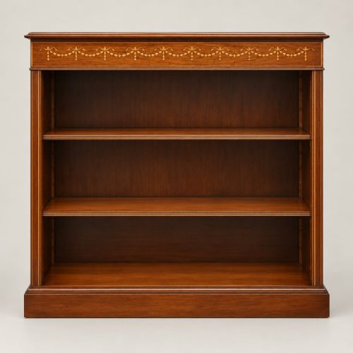 fig 2. A low mahogany open bookcase featuring three adjustable shelves, fine boxwood line stringing, and an inlaid swag garland motif along the upper frieze.