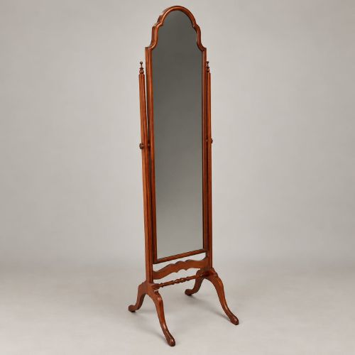 fig 2. A 1920s full-length mahogany cheval mirror featuring an arched top frame, upright side posts with finials, turned cross-stretcher, and splayed feet.