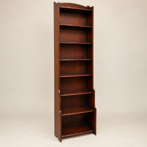 fig 1. A tall and narrow dark oak waterfall bookcase circa 1920 with six open shelves graduating in depth.