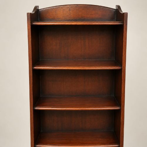 fig 2. A tall and narrow dark oak waterfall bookcase circa 1920 with six open shelves graduating in depth.