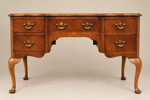 A SERPENTINE FRONTED BURR WALNUT DESK C1920