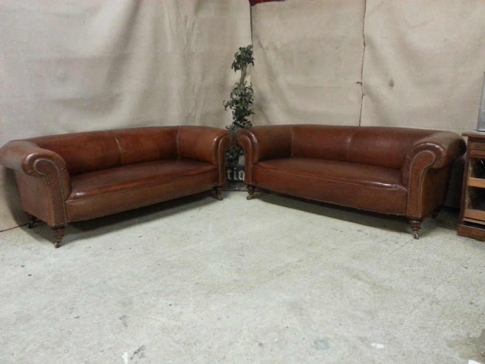 ORIGINAL MATCHING PAIR OF ANTIQUE VICTORIAN BROWN LEATHER FULL HIDE CHESTERFIELD THREE SEATER SOFAS C1890