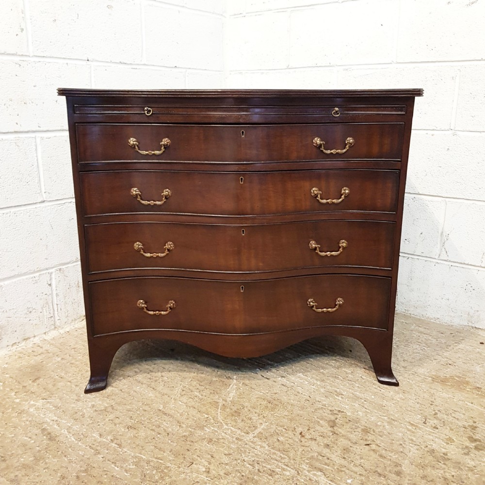 ANTIQUE MAHOGANY SERPENTINE SHAPED CHEST OF DRAWERS WITH BRUSHING SLIDE C1920 View II