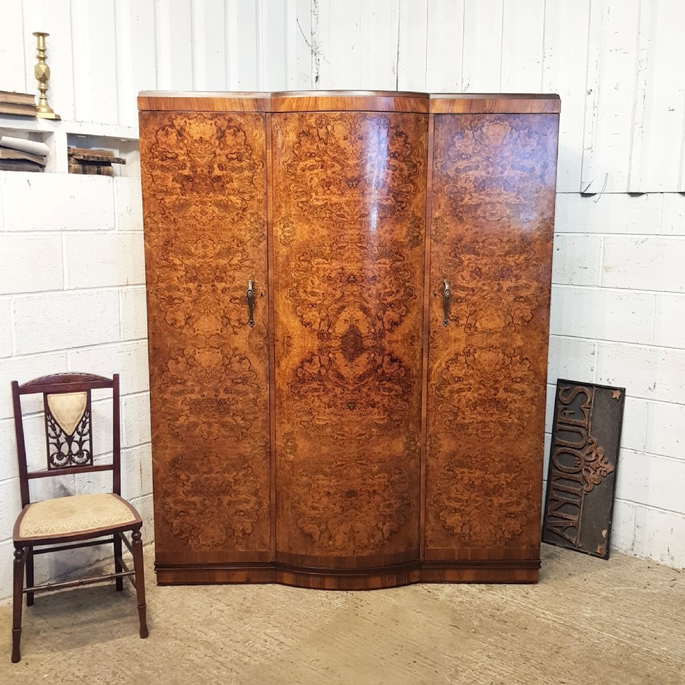 ANTIQUE BURR WALNUT SERPENTINE SHAPED TRIPLE WARDROBE C1920