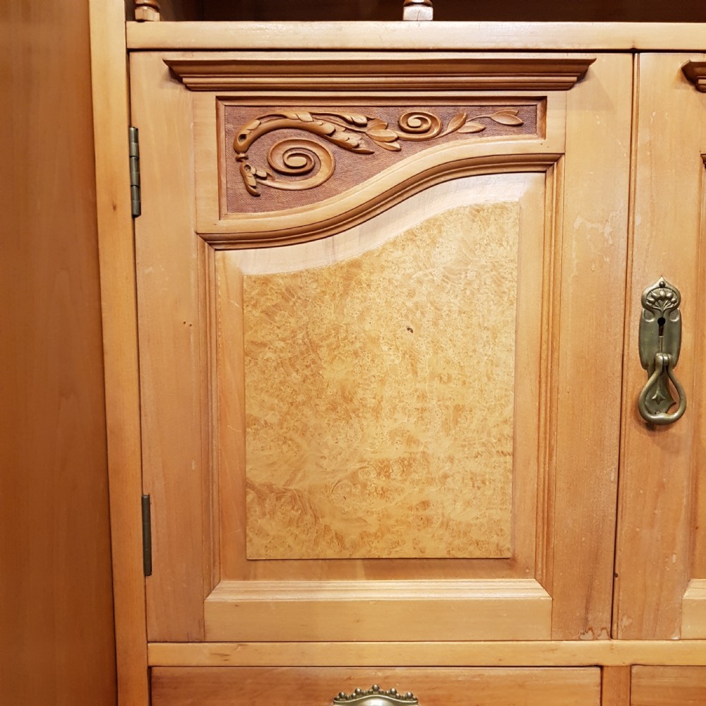 An antique Victorian satin walnut and maple combination wardrobe featuring two tall outer sections with mirrored doors flanking a central chest of drawers and small upper cupboard. View VI