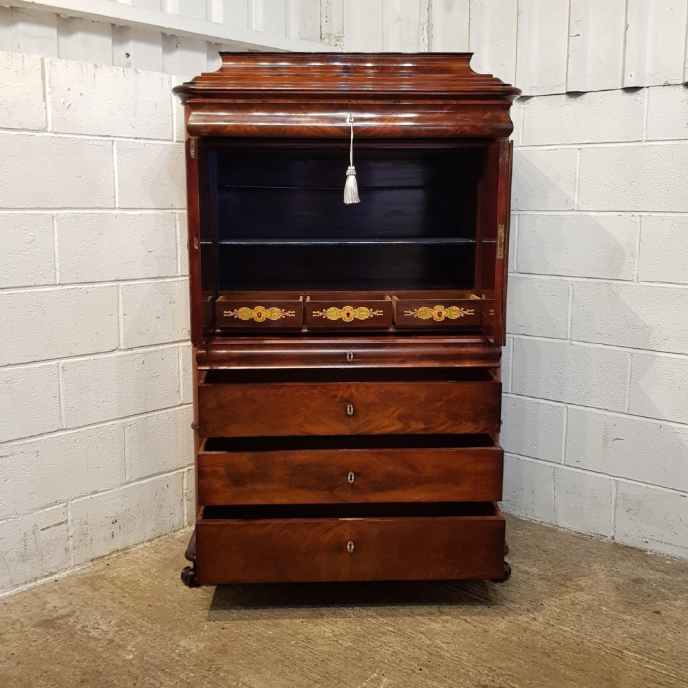A nineteenth-century Biedermeier flame mahogany tall storage cabinet featuring double upper doors with figure-matched veneer and three full-width lower drawers. View II