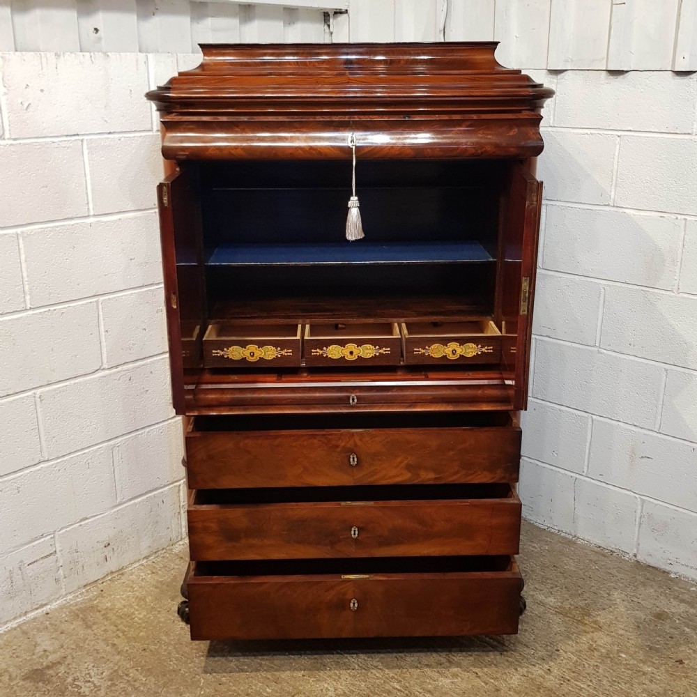 A nineteenth-century Biedermeier flame mahogany tall storage cabinet featuring double upper doors with figure-matched veneer and three full-width lower drawers. View III