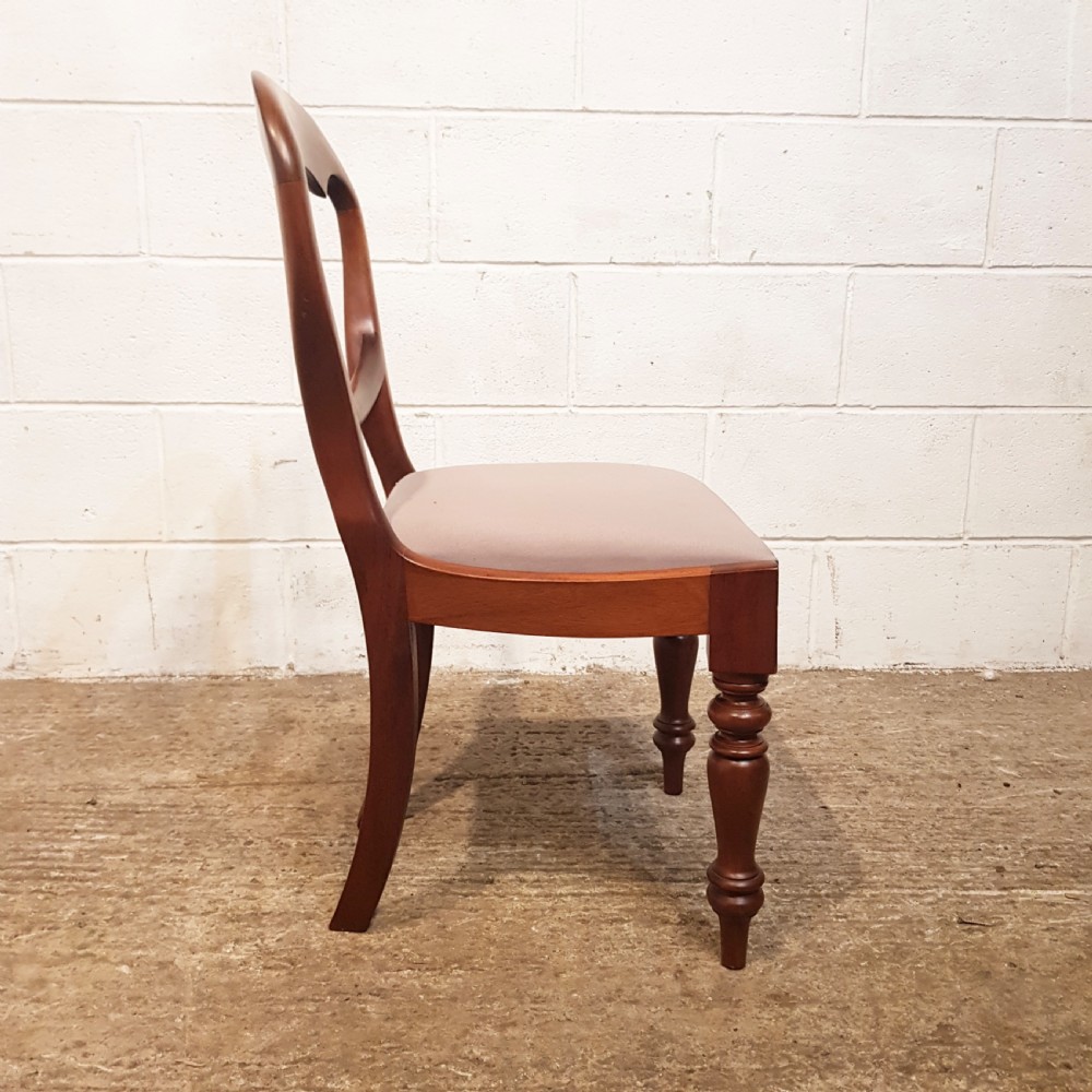 A set of six Victorian mahogany dining chairs featuring open balloon back frames, turned front legs, and neutral upholstered seats. View II