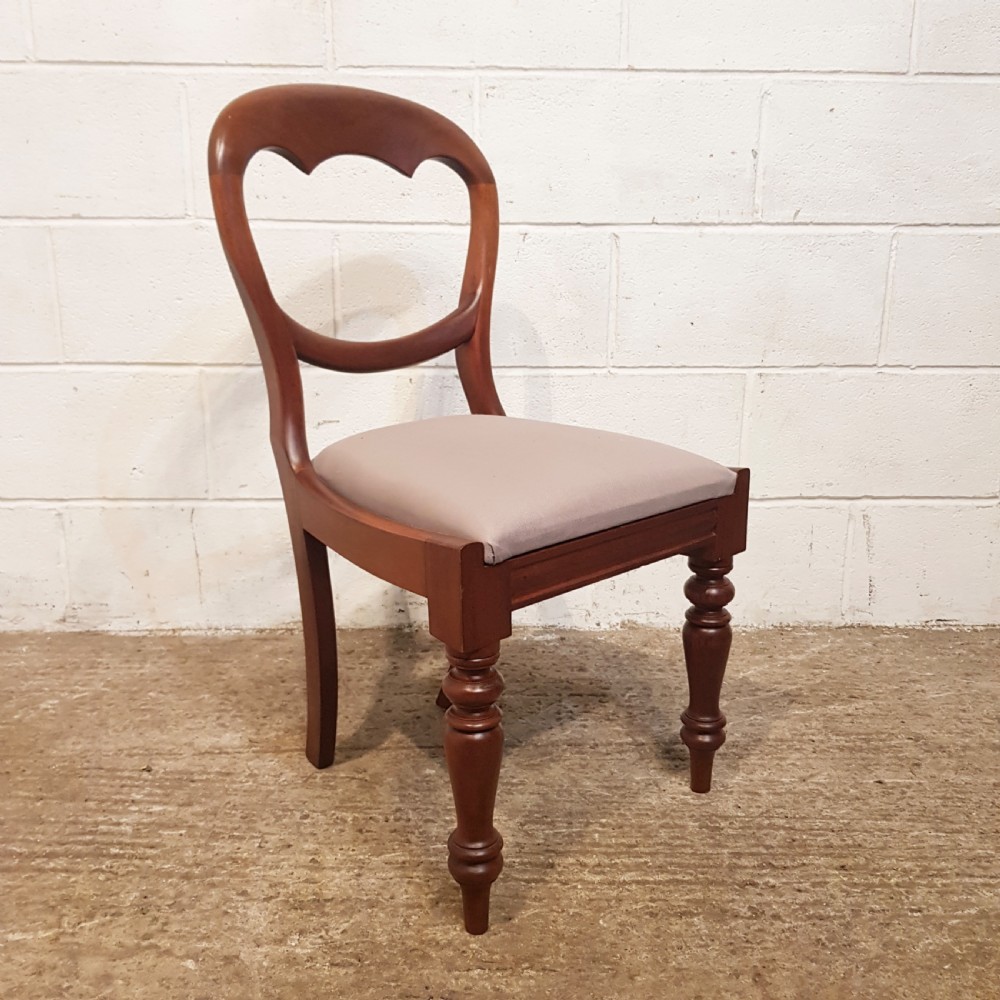 A set of six Victorian mahogany dining chairs featuring open balloon back frames, turned front legs, and neutral upholstered seats. View VII