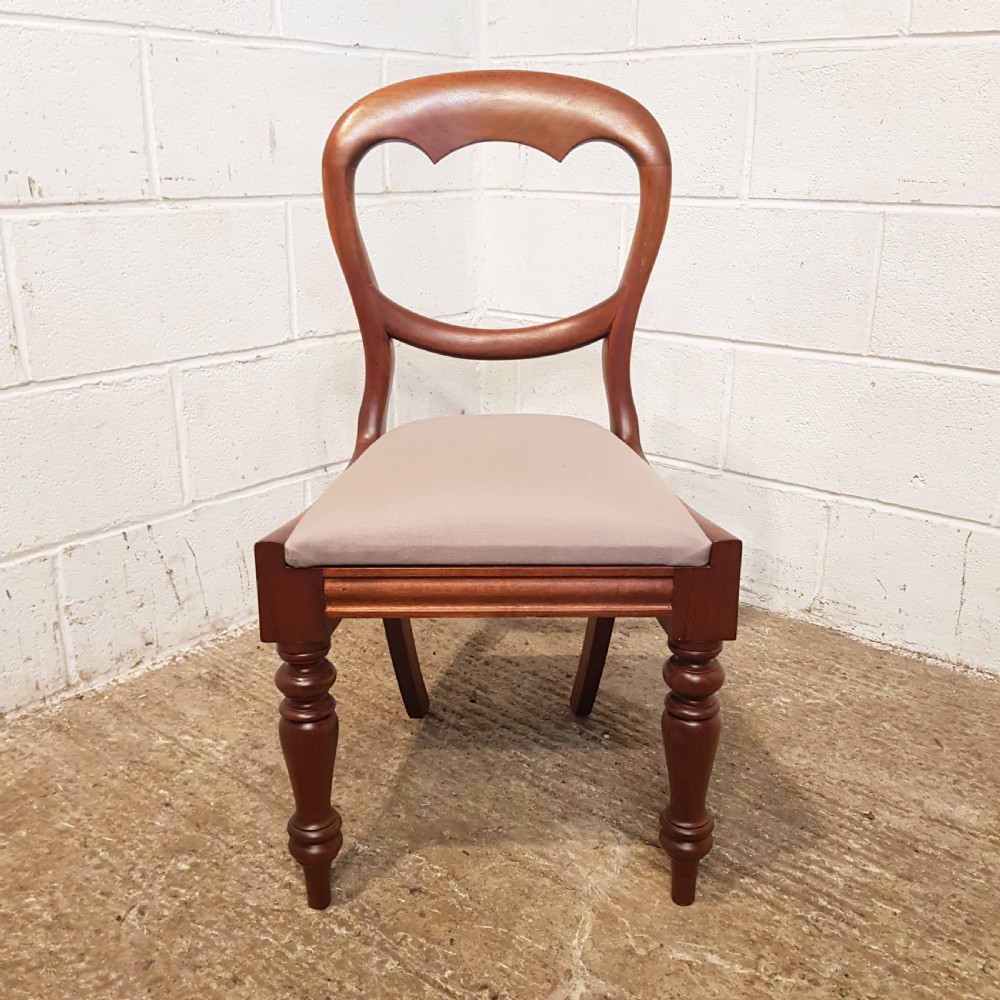 A set of six Victorian mahogany dining chairs featuring open balloon back frames, turned front legs, and neutral upholstered seats. View IX