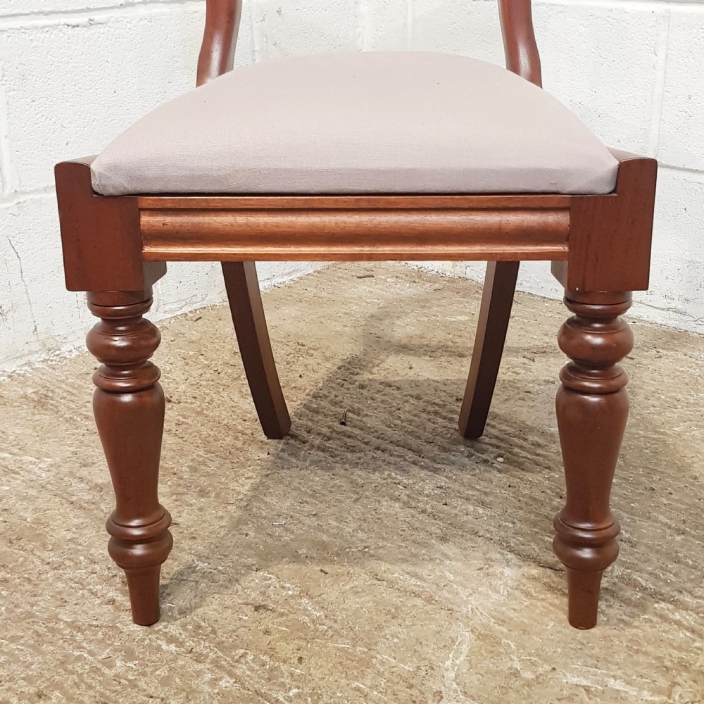 A set of six Victorian mahogany dining chairs featuring open balloon back frames, turned front legs, and neutral upholstered seats. View X