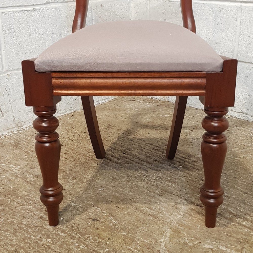 A set of six Victorian mahogany dining chairs featuring open balloon back frames, turned front legs, and neutral upholstered seats. View XI