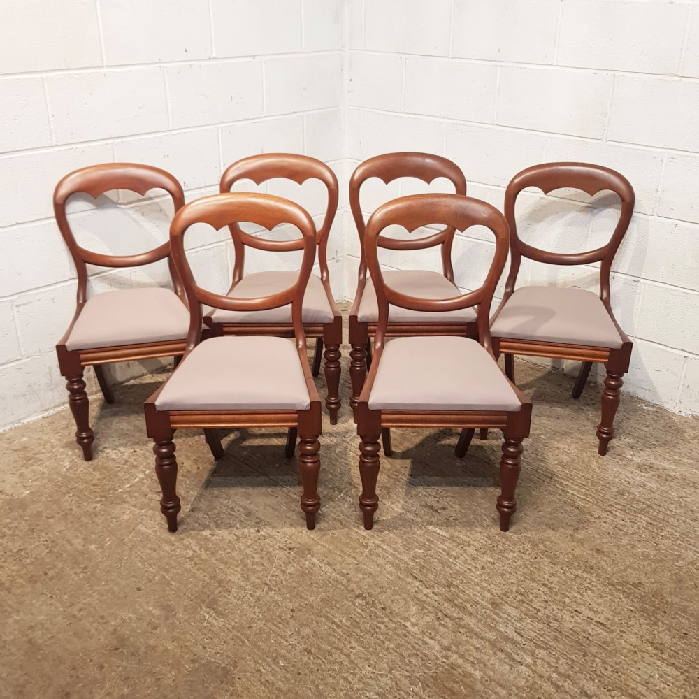 A set of six Victorian mahogany dining chairs featuring open balloon back frames, turned front legs, and neutral upholstered seats. View XIII