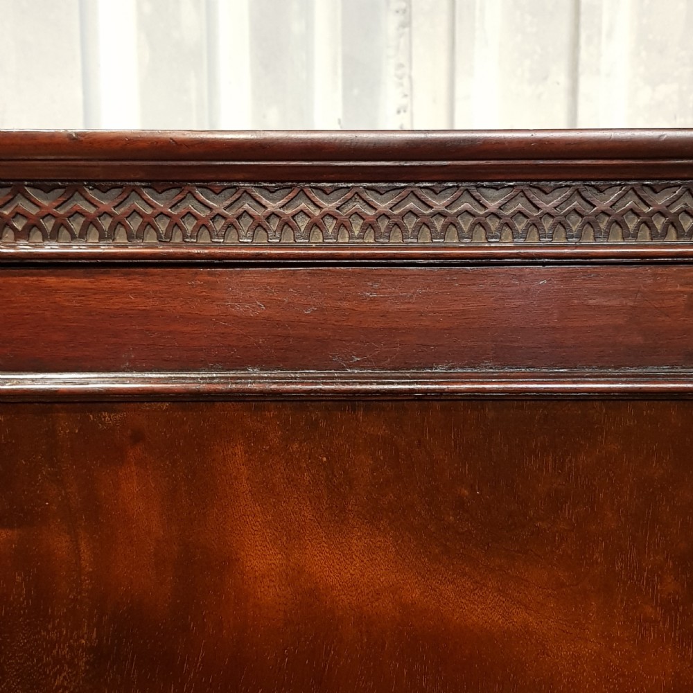 An eighteenth-century mahogany double wardrobe featuring flame mahogany panel doors decorated with carved corner rosettes and resting on bracket feet. View VI