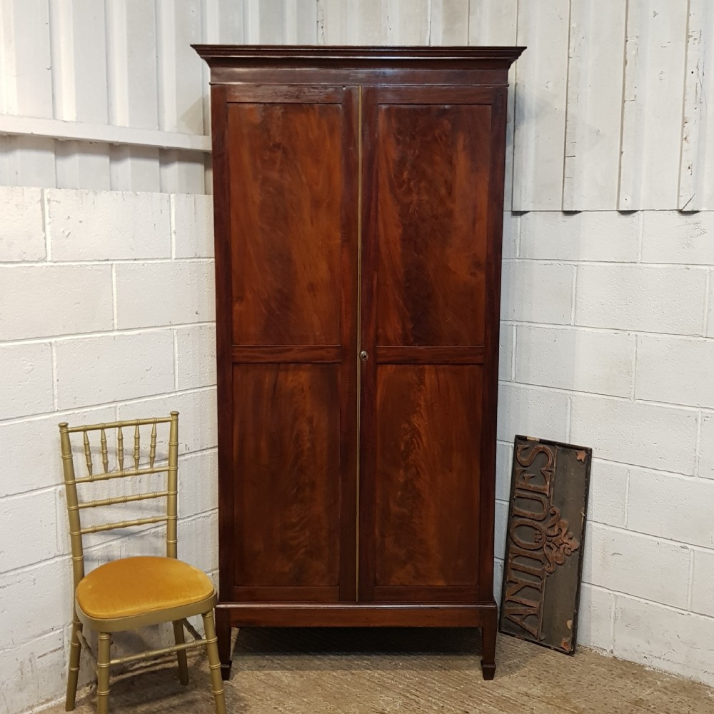 AN ANTIQUE REGENCY MAHOGANY SMALL WARDROBE C1810