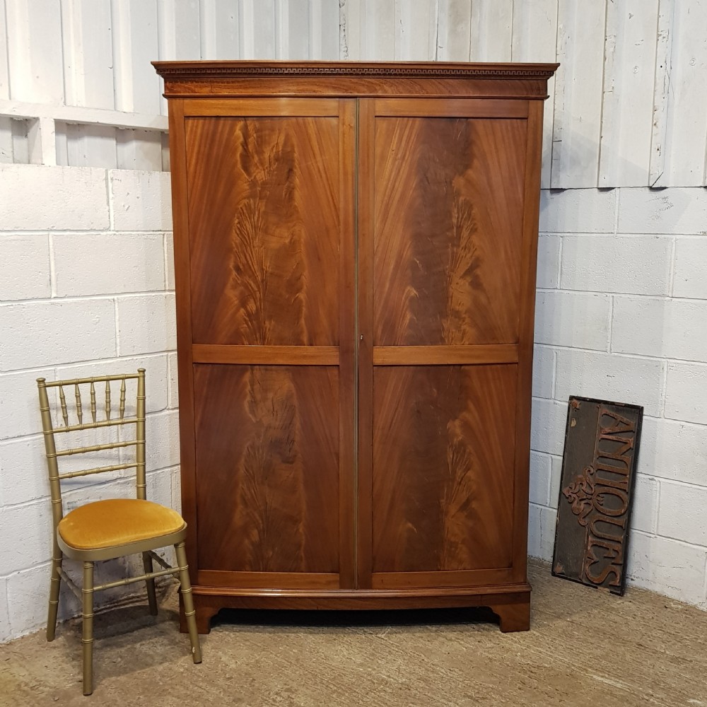 AN ANTIQUE LATE VICTORIAN MAHOGANY BOW FRONTED DOUBLE WARDROBE C1900
