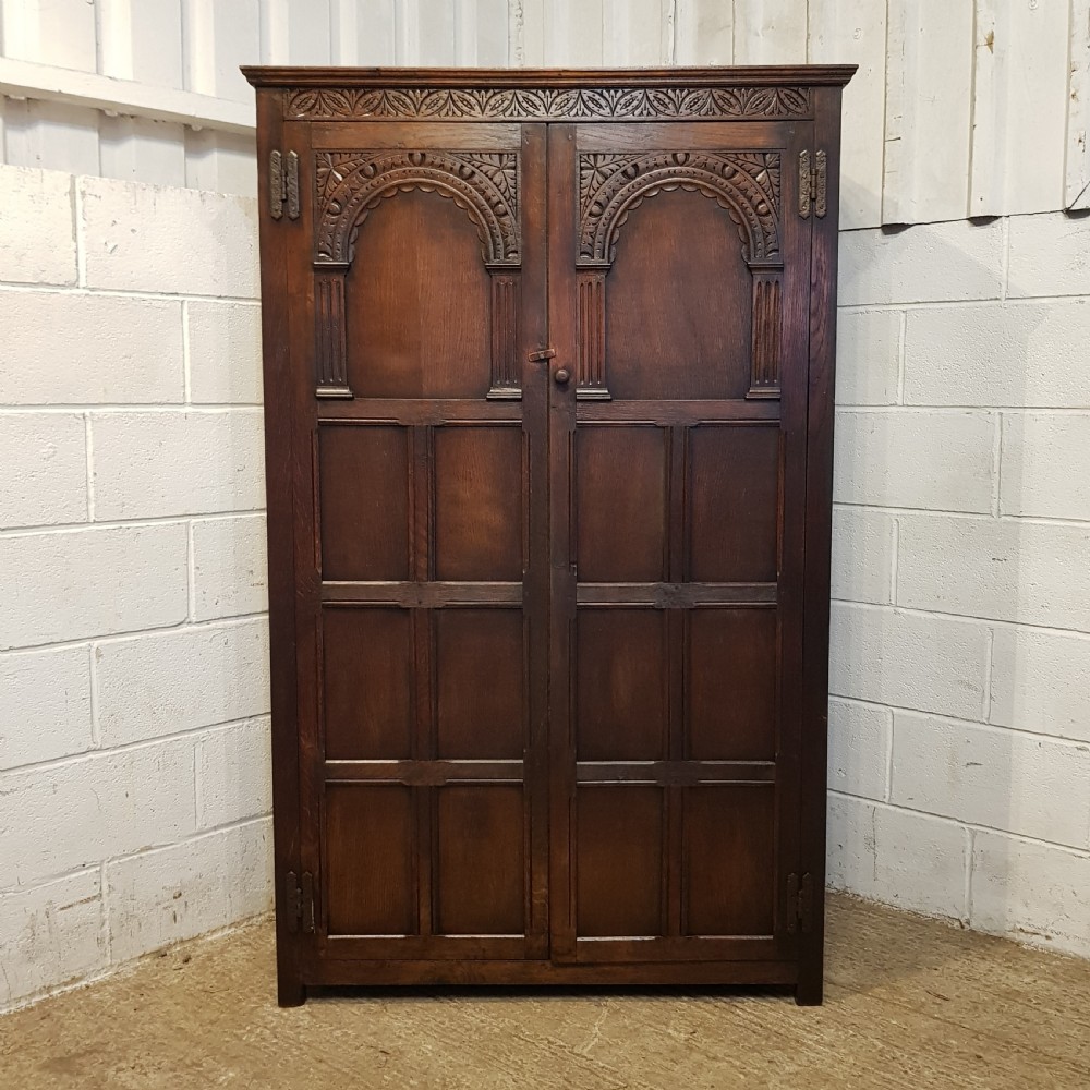 AN ANTIQUE OAK CARVED DOUBLE WARDROBE C1920