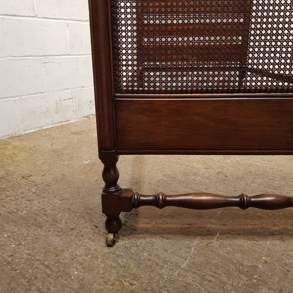 BY HEALS OF LONDON AN ANTIQUE PAIR OF WALNUT FRAMED SINGLE BEDS WITH BERGERE PANELS C1900 View IV